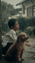 Side view of young man with dog