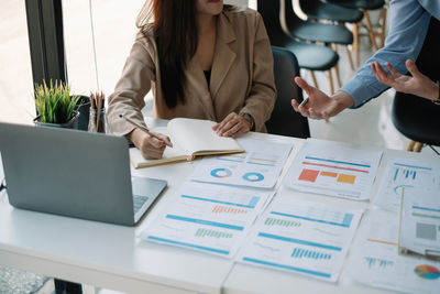 Midsection of business colleagues working at office