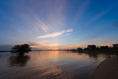 Scenic view of swimming pool against sky during sunset