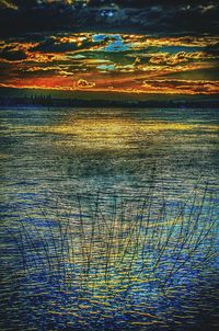 Scenic view of lake against sky at sunset