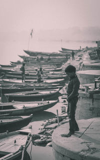 Side view of man standing on shore against sky