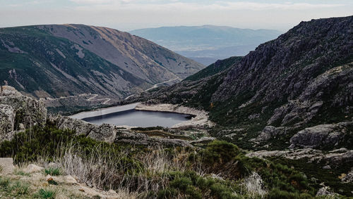Scenic view of lake and mountains against sky