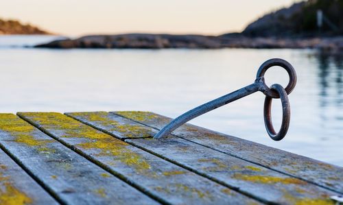 Close-up of metal railing on pier over lake