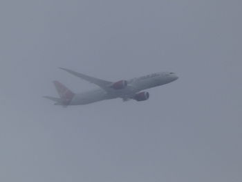 Low angle view of airplane flying in sky