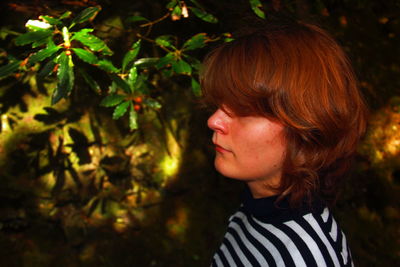 Close-up of redhead teenage girls by plant