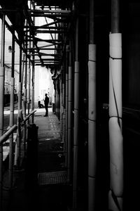 Man standing on sidewalk in city