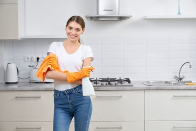 Smiling young woman standing at home