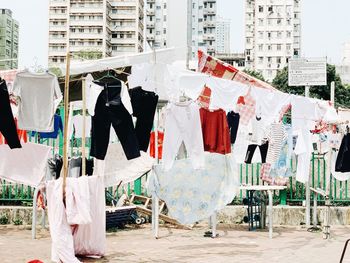 Clothes drying against buildings in city