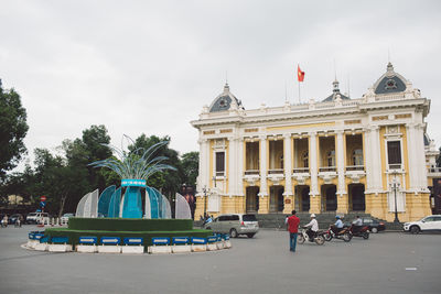 Historic building by street in city