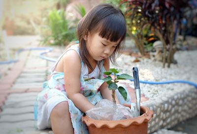 Cute girl sitting outdoors