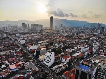 High angle view of buildings in city against sky during sunset