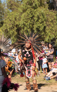 Young woman dancing against trees