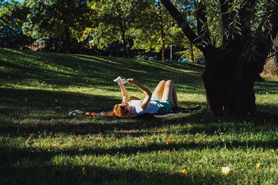 Girl reading a book under a tree