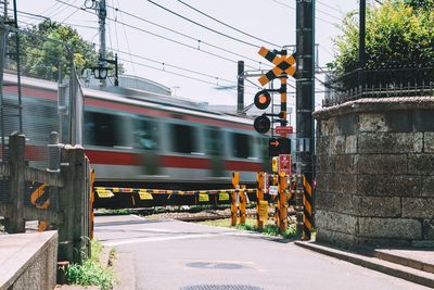 Blurred motion of train on street in city