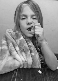 Portrait of girl eating food at home