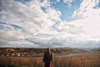 Woman standing on land against sky