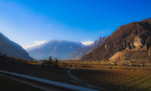 Scenic view of mountains against blue sky