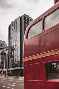 View of train against buildings in city