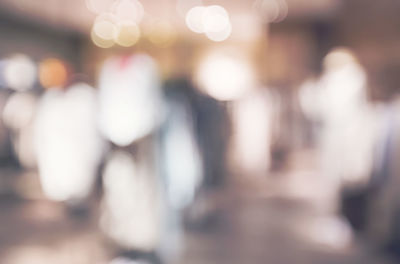 Defocused image of woman standing in illuminated city