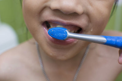 Close-up of girl brushing teeth