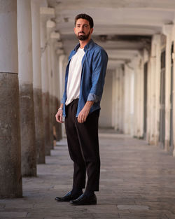 Portrait of man standing in building