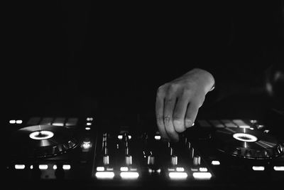 Close-up of person hand against black background