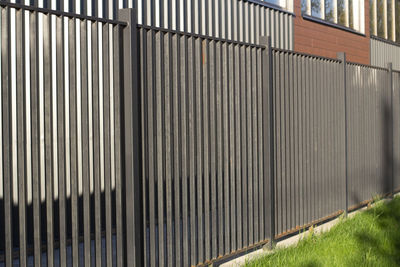 Metal fence by wall