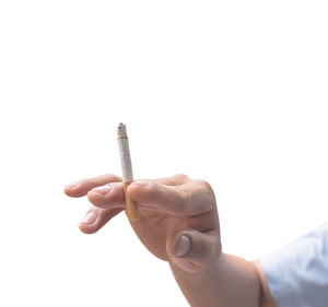 Close-up of person holding hands against white background