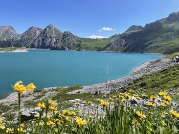Scenic view of sea and mountains against sky