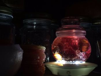 Close-up of candle in dark room
