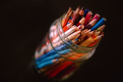 Close-up of colored pencils against black background