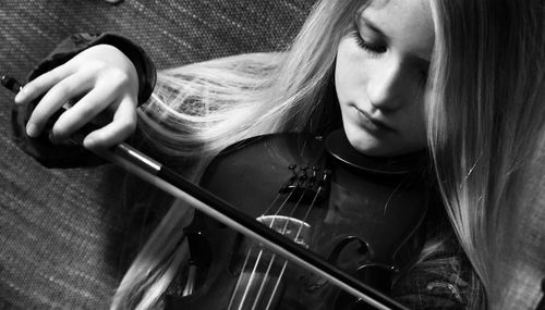 Close-up of girl playing violin