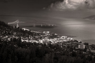 Bridge over sea in city against sky