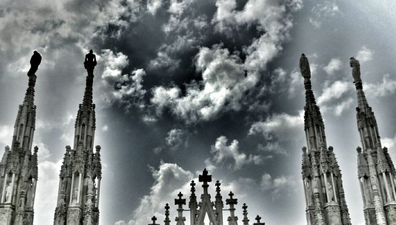 low angle view, architecture, building exterior, built structure, sky, religion, place of worship, cloud - sky, spirituality, famous place, travel destinations, international landmark, tall - high, city, church, travel, cloudy, cloud, capital cities