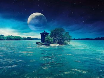 Scenic view of sea against moon at night