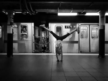 Rear view of man standing at subway station