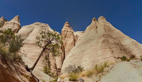 Low angle view of rock formation against sky