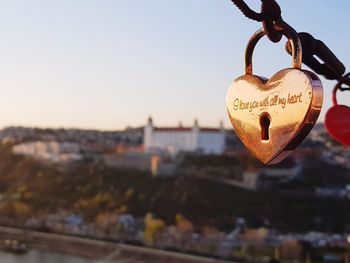 Close-up of padlocks hanging on heart shape