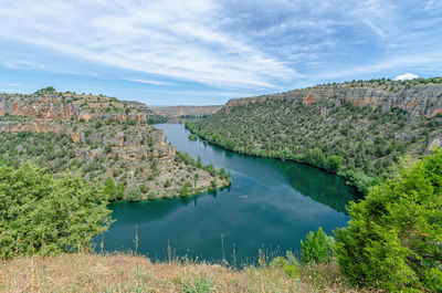 Scenic view of lake and trees against sky