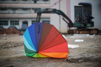 Close-up of multi colored umbrella on street