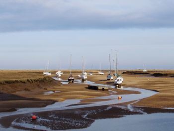 Sailboats in sea against sky