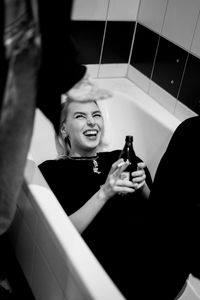 High angle view of woman lying in bathtub