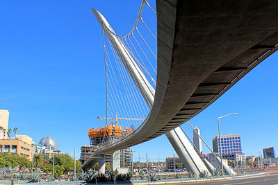 Low angle view of bridge against buildings in city