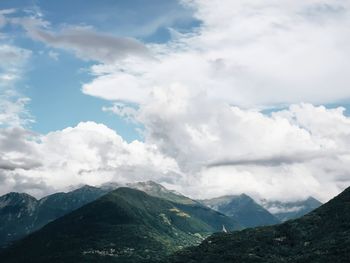 Scenic view of mountains against cloudy sky