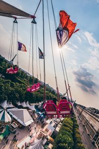 Chain swing against cloudy sky