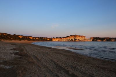 Scenic view of beach against sky during sunset