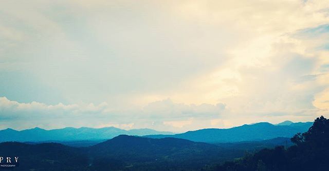 mountain, mountain range, scenics, tranquil scene, sky, tranquility, beauty in nature, landscape, cloud - sky, nature, idyllic, cloud, non-urban scene, cloudy, tree, outdoors, no people, remote, silhouette, hill