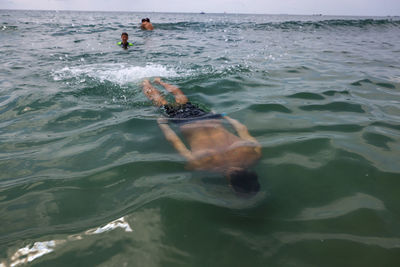 High angle view of man swimming in sea