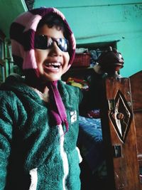 Portrait of smiling boy holding camera