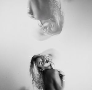 Portrait of a young woman against white background